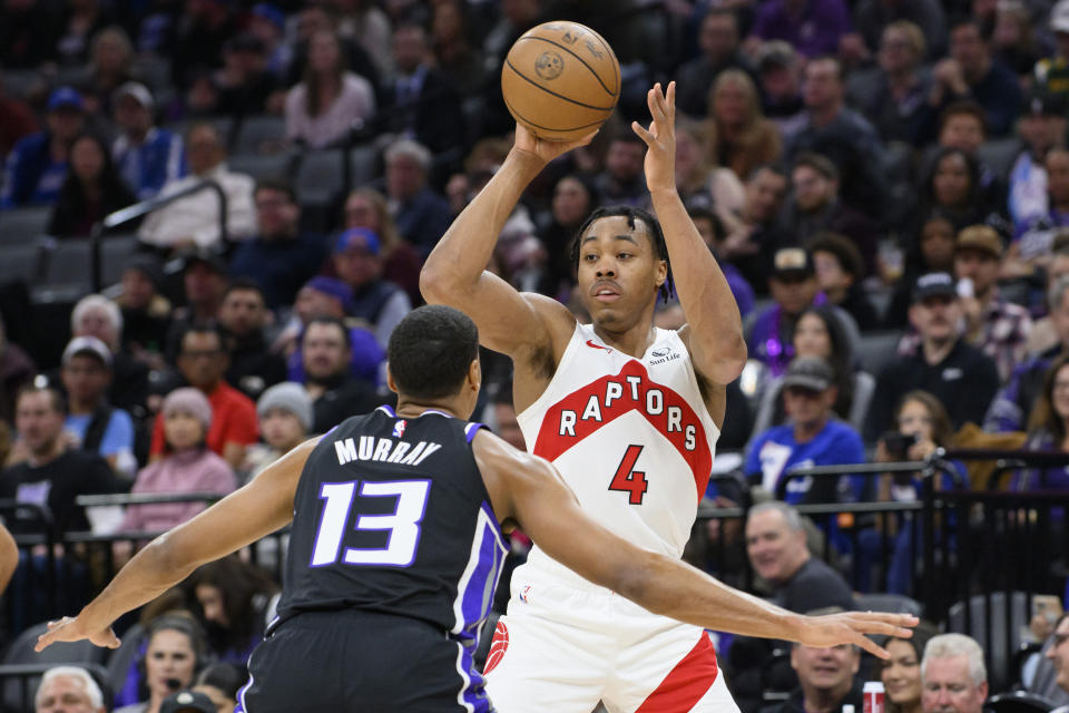 Toronto Raptors forward Scottie Barnes (4) is guarded by Sacramento Kings forward Keegan Murray (13) during the first quarter of an NBA basketball game in Sacramento, Calif., Friday, Jan. 5, 2024. (AP Photo/Randall Benton)