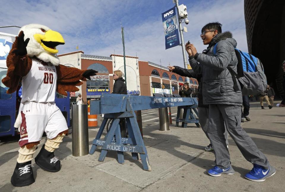 Onlookers delight at the sight of the Boston College mascot, "Baldwin, the Eagle," as he steps off a bus outside the Barclays Center, Monday, March 6, 2017, in New York. All 15 of the Atlantic Coast Conference's mascots were on hand to promote the ACC college basketball tournament, which will be played March 7-11 at the Barclays Center in Brooklyn. (AP Photo/Kathy Willens)