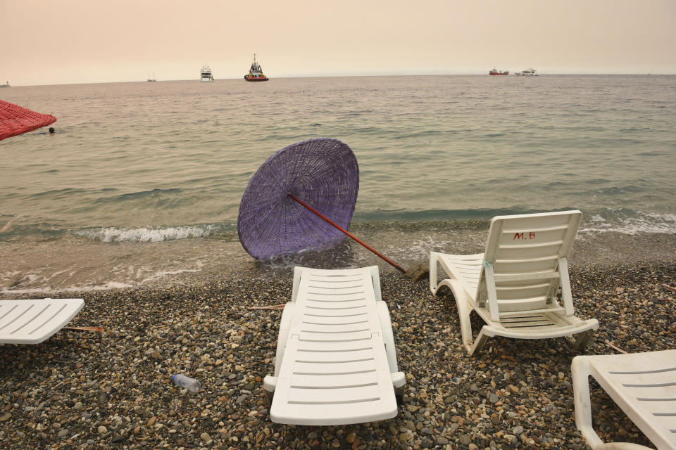 The Oren beach shortly after people were evacuated by boat after wildfires reached the nearby Kemerkoy Power Plant, a coal-fueled power plant, in Milas, Mugla in southwest Turkey, early Thursday, Aug. 5, 2021. (AP Photo)