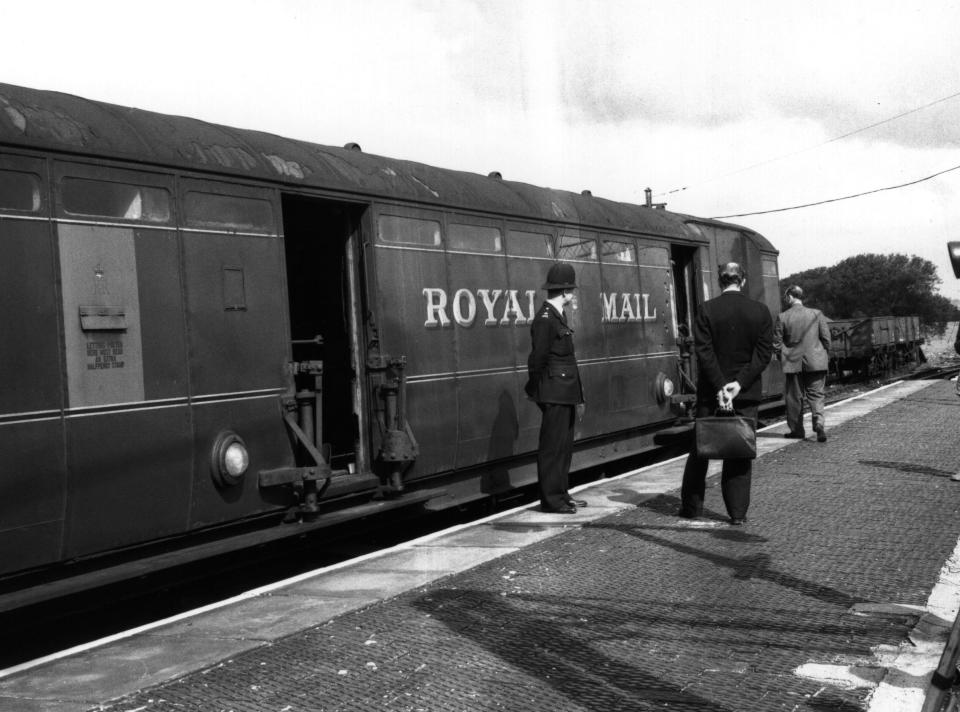 Investigators examine the Royal Mail train involved in the Great Train Robbery.