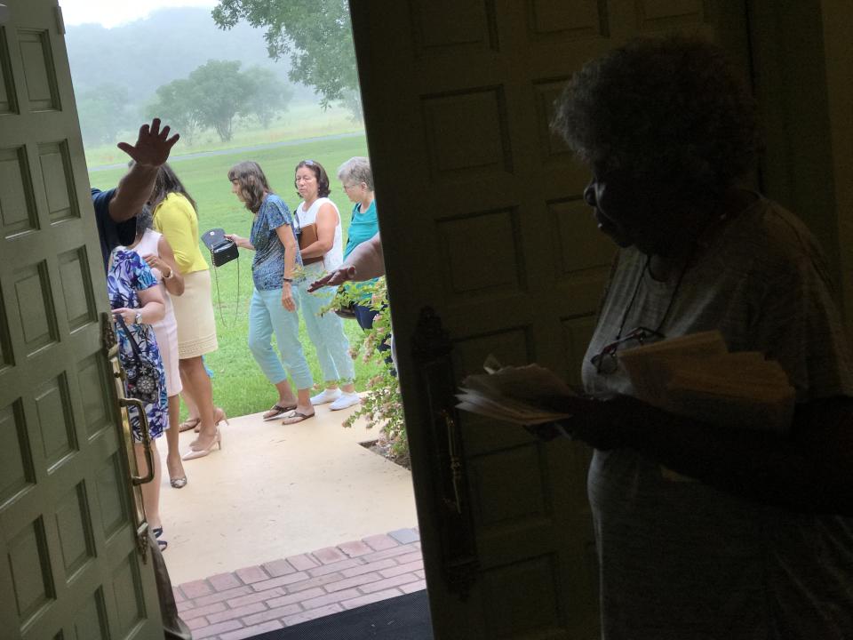 Mary Prince, a resident of Plains since 1981, holds church service programs and waits for visitors to be screened by Secret Service agents at the door of Maranatha Baptist Church, before entering to see former President Jimmy Carter teach Sunday school. Carter has continued to teach twice a month despite battling brain cancer that was diagnosed in 2015 and is now in remission. He was out less than a month earlier this year after he broke his hip. (Photo: Jon Ward/Yahoo News)