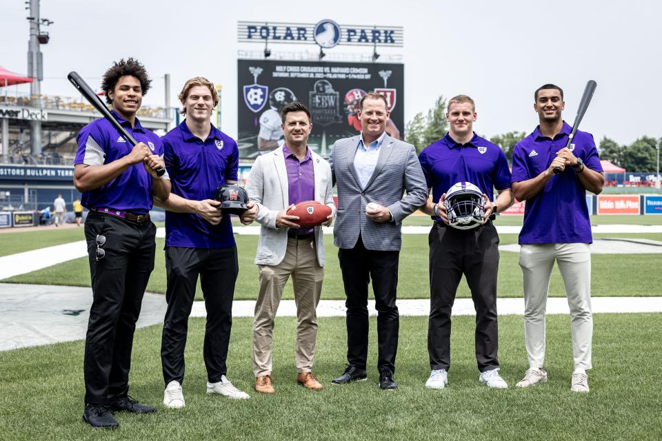 Holy Cross football coaches and captains pose for a picture to promote their upcoming game against Harvard on Sept. 30 at Polar Park in Worcester.