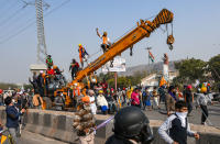 NEW DELHI, INDIA - JANUARY 26: Farmers breaking past police barricades while heading out from Singhu border and into the national capital on a tractor rally on Republic Day on January 26, 2021 near New Delhi, India. Major scenes of chaos and mayhem at Delhi borders as groups of farmers allegedly broke barricades and police check posts and entered the national capital before permitted timings. Police used tear gas at Delhi's Mukarba Chowk to bring the groups under control. Clashes were also reported at ITO, Akshardham. Several rounds of talks between the government and protesting farmers have failed to resolve the impasse over the three farm laws. The kisan bodies, which have been protesting in the national capital for almost two months, demanding the repeal of three contentious farm laws have remained firm on their decision to hold a tractor rally on the occasion of Republic Day.(Photo by Amal KS/Hindustan Times via Getty Images)