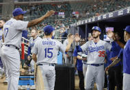 Los Angeles Dodgers' Cody Bellinger celebrates after scoring on a double by Chris Taylor during the eleventh inning of a baseball game against the Atlanta Braves on Sunday, June 26, 2022, in Atlanta. The Dodgers won 5-3. (AP Photo/Bob Andres)