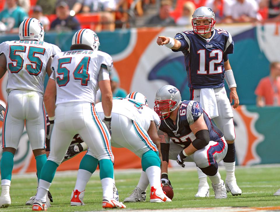 Oct 21, 2007; Miami, FL, USA; New England Patriots quarterback (12) Tom Brady points at Miami Dolphins linebacker (54) Zach Thomas  and Miami Dolphins linebacker (55) Joey Porter during the first quarter at Dolphin Stadium. The Patriots won 49-28. Mandatory Credit: Steve Mitchell-USA TODAY Sports