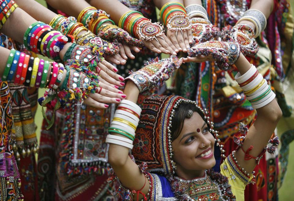 A girl dressed in traditional attire poses as she takes part in rehearsals for garba dance ahead of Navratri festival in Ahmedabad