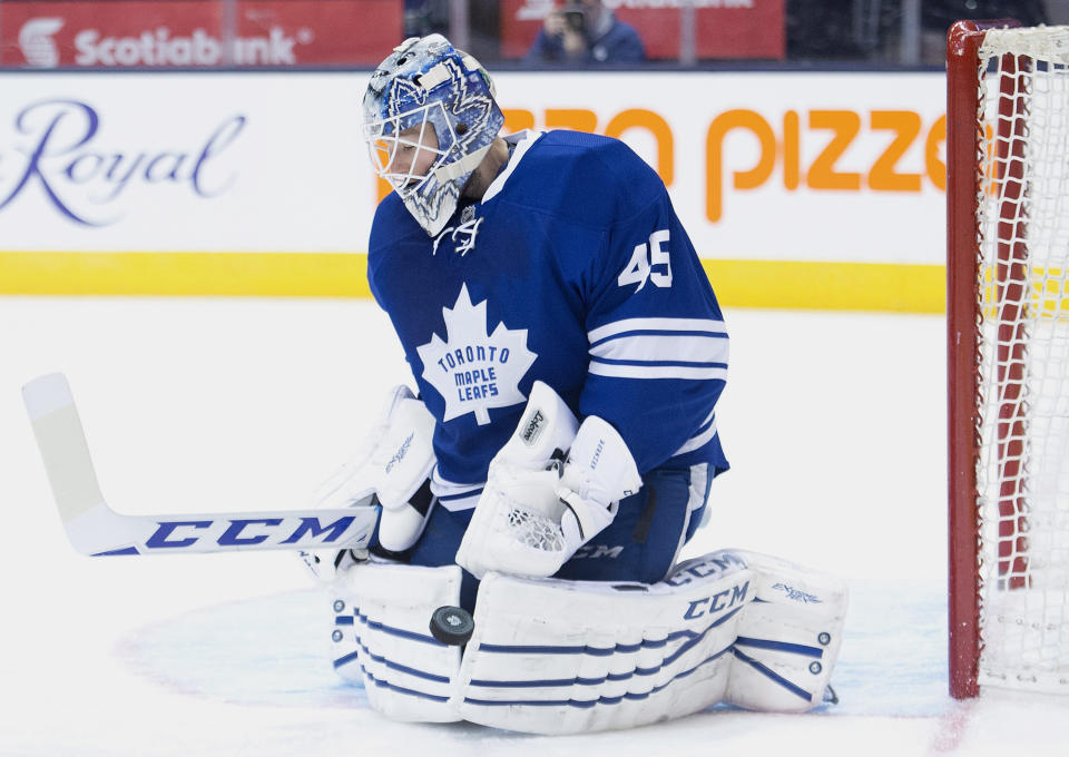 Toronto Maple Leafs goalie Jonathan Bernier makes a save against the Vancouver Canucks during third period NHL hockey action in Toronto on Saturday, Dec. 6, 2014. (AP Photo/The Canadian Press,Nathan Denette)