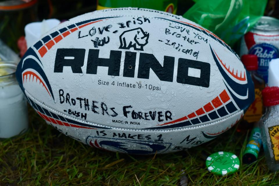 A rugby ball awash in Sharpied signatures.