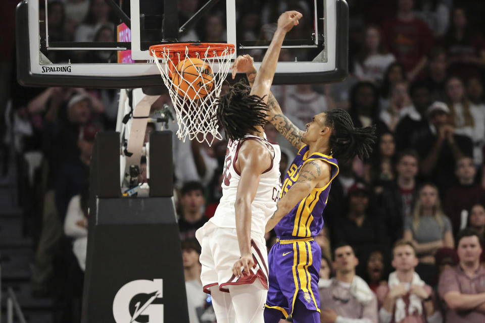 LSU forward Tyrell Ward (15) dunks over South Carolina forward Collin Murray-Boyles (30) during the second half of an NCAA college basketball game Saturday, Feb. 17, 2024, in Columbia, S.C. (AP Photo/Artie Walker Jr.)