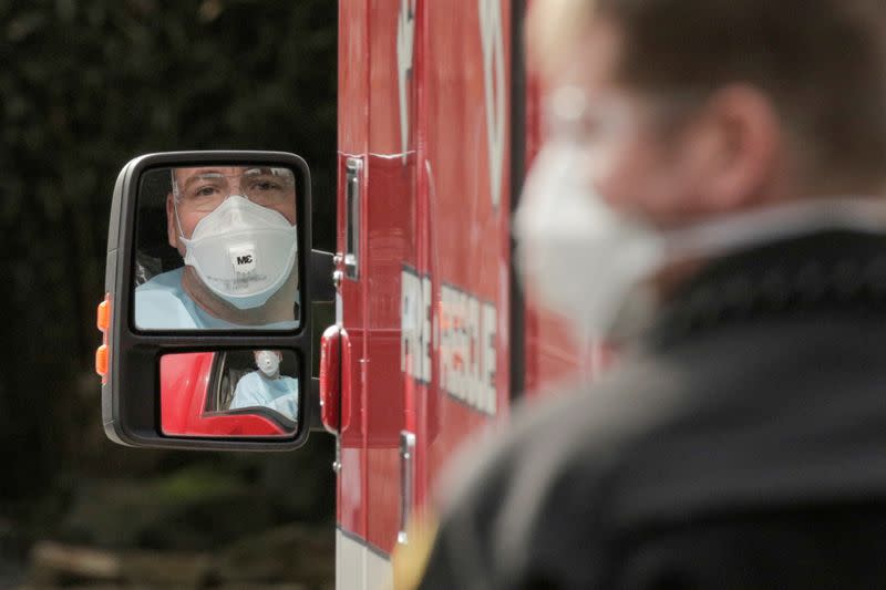 FILE PHOTO: A medic drives an ambulance at the Life Care Center of Kirkland, the long-term care facility linked to several confirmed coronavirus cases in the state, in Kirkland