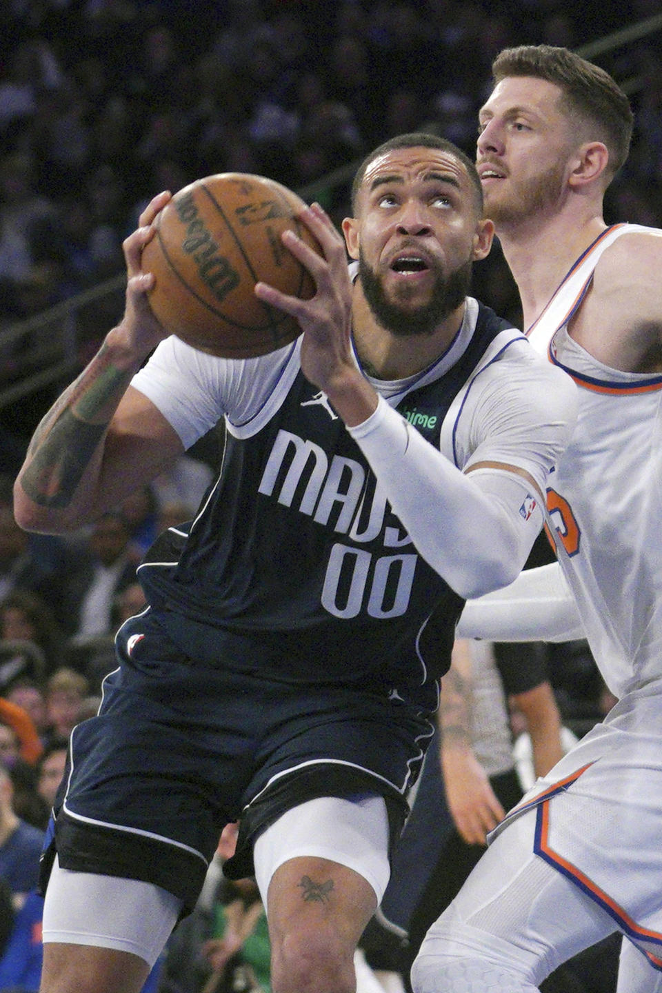 Dallas Mavericks center JaVale McGee, left, drives the lane to the basket, during the first quarter of an NBA basketball game against New York Knicks, Saturday, Dec. 3, 2022, in New York. (AP Photo/Bebeto Matthews)