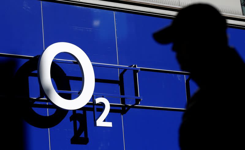 FILE PHOTO: A man walking past an O2 phone store in Manchester