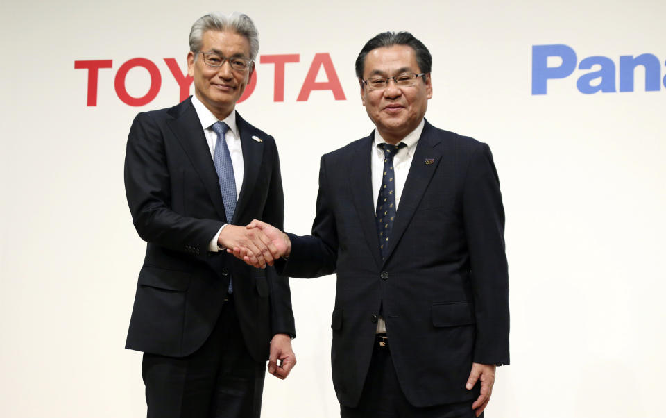 Operating Officer of Toyota Motor Corporation Masayoshi Shirayanagi, left, and senior Managing Executive Officer of Panasonic Corporation Makoto Kitano shake hands after their press conference in Tokyo, Thursday, May 9, 2019. Japanese automaker Toyota and electronics maker Panasonic are forming a joint venture combining their housing businesses in Japan. (AP Photo/Koji Sasahara)