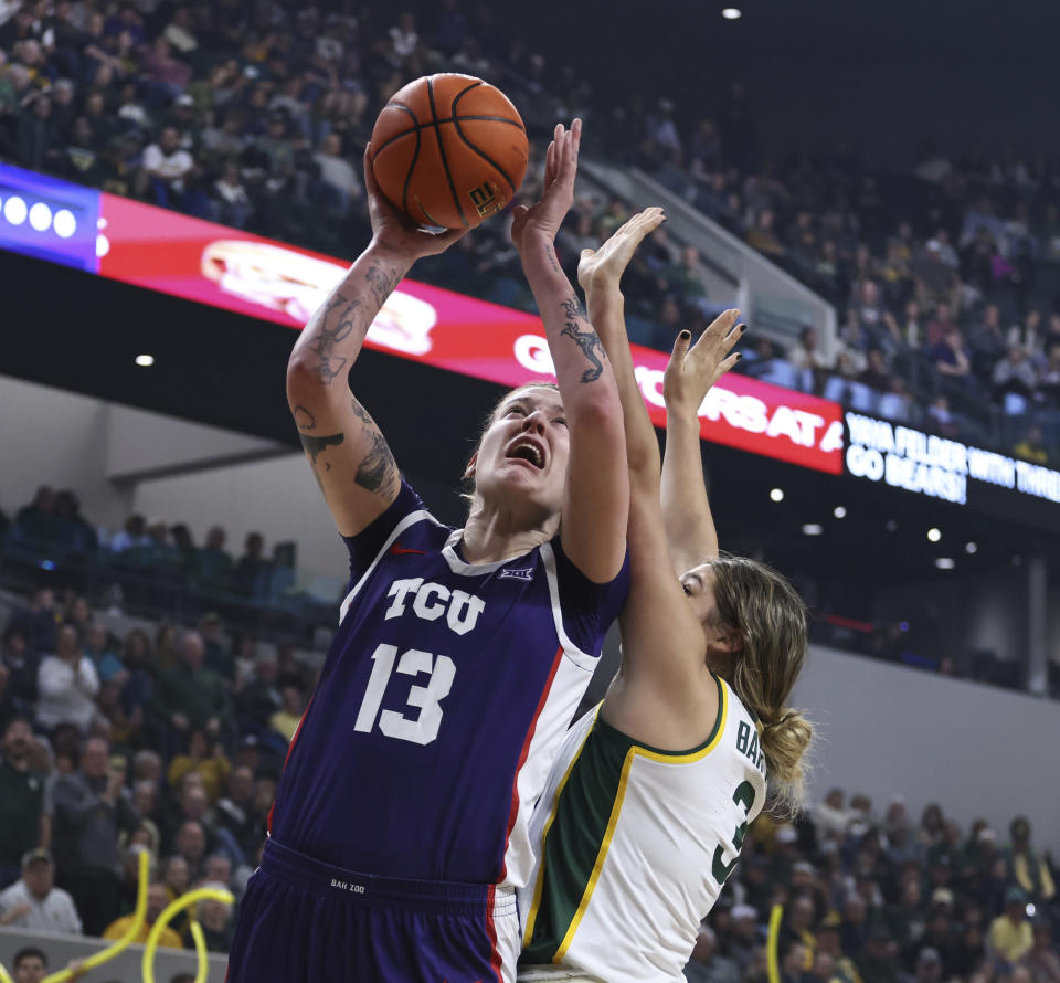 TCU forward Sedona Prince shoots next to Baylor forward Madison Bartley during the first half of an NCAA college basketball game Wednesday, Jan. 3, 2024, in Waco, Texas. (Rod Aydelotte/Waco Tribune-Herald via AP)