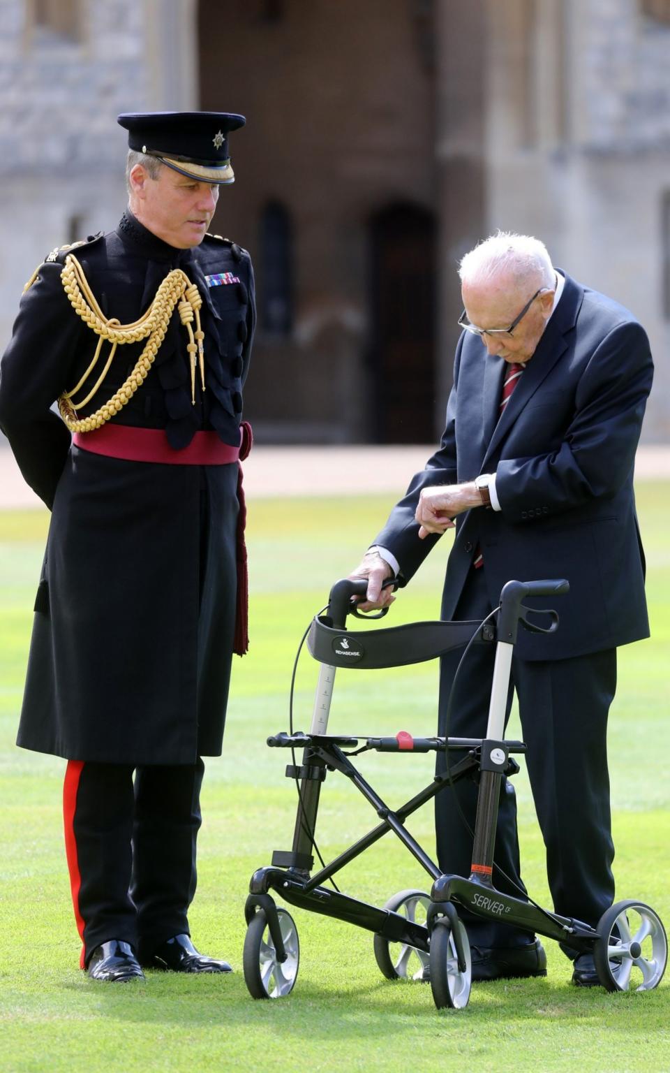 Captain Sir Thomas Moore arrives prior being awarded with the insignia of Knight Bachelor by Queen Elizabeth II at Windsor Castle on July 17, 2020 in Windsor, England. British World War II veteran Captain Tom Moore raised over £32 million for the NHS during the coronavirus pandemic. - Chris Jackson