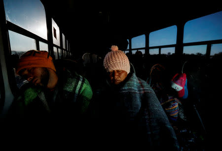 Migrants, part of a caravan of thousands traveling from Central America to the United States, ride on a bus which is on the way to Mexicali, in Navojoa, Mexico November 17, 2018. REUTERS/Kim Kyung-Hoon?