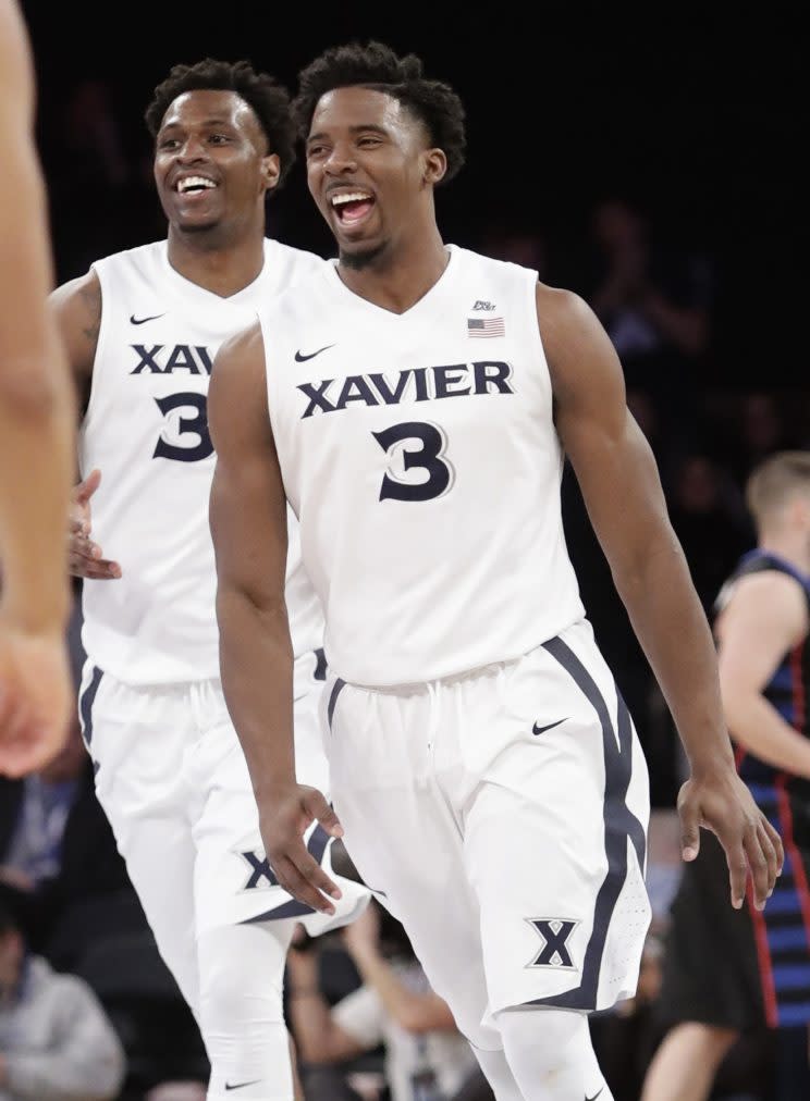 Xavier’s Quentin Goodin (3) celebrates with teammate RaShid Gaston after dunking against DePaul during the second half of an NCAA college basketball game in the Big East men’s tournament Wednesday, March 8, 2017, in New York. Xavier won 75-64. (AP Photo/Frank Franklin II)