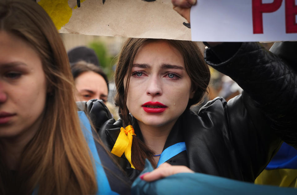 A woman cries as relatives and activists take part in a rally in central Kyiv, Ukraine, Saturday, April 30, 2022, demanding international leaders to organize a humanitarian corridor for evacuation of Ukrainian military and civilians from Mariupol, amid Russia's invasion of Ukraine. (AP Photo/Efrem Lukatsky)
