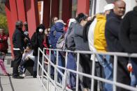 FILE - In this March 17, 2020, file photo, people wait in line for help with unemployment benefits at the One-Stop Career Center in Las Vegas. Nevada jobless figures continue to climb, with more than 18,000 people filing first-time claims for benefits last week. That will add to the record 28.2% statewide unemployment figure in April. The U.S. Labor Department tally on Thursday, May 28 comes after the state last week reported that Nevada unemployment is higher than any state ever, topping even the 25% nationwide estimates made during the Great Depression. (AP Photo/John Locher, File)