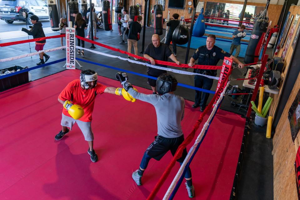 Three Shields Boxing Academy trainer Derrick Campos, left, spars with 17-year-old Jalim Ramirez on Tuesday evening. The program, which started in 2020, came together from a joint effort between Topeka Fire Department, Topeka Police Department and the Salvation Army.