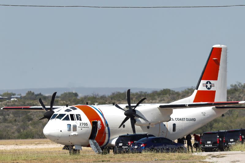 People board an U.S. Coast Guard airplane at the Del Rio International Airport as U.S. authorities accelerate removal of migrants at border with Mexico, in Del Rio