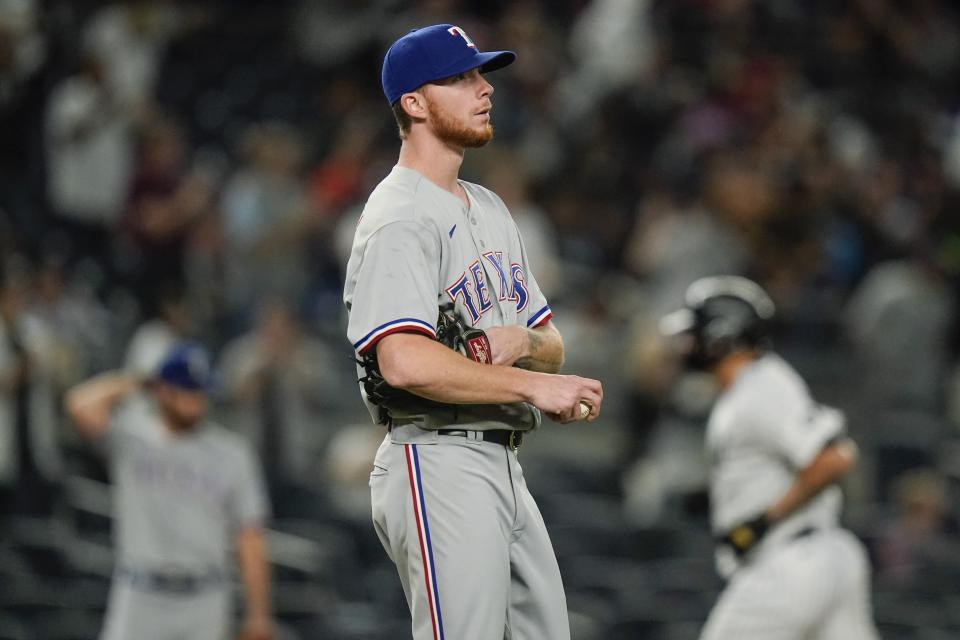 Texas Rangers starting pitcher A.J. Alexy, foreground, reacts as New York Yankees' Gary Sanchez runs the bases after hitting a home run during the second inning of a baseball game Monday, Sept. 20, 2021, in New York. (AP Photo/Frank Franklin II)