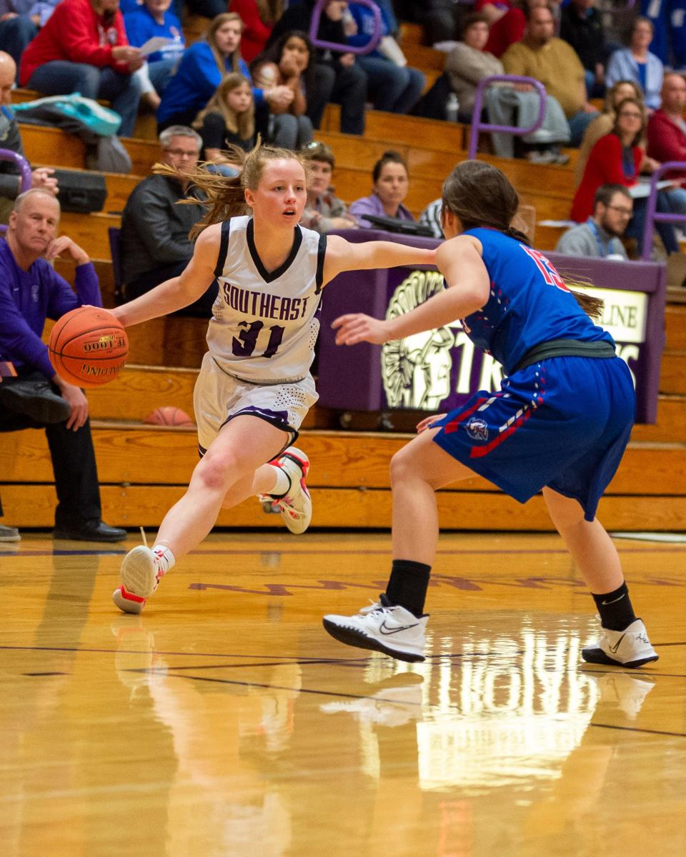 Maddie Harris of Southeast of Saline (31) drives against Republic County's Kadence Henke (13) in Tuesday's Trojan victory, 63-13, over the visiting Buffaloes.