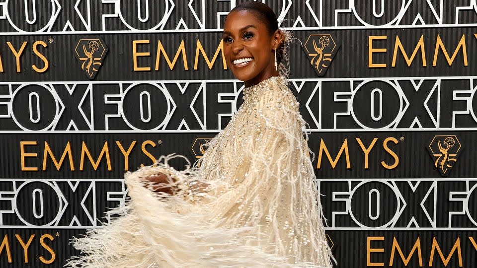 Issa Rae in a feathery Pamella Roland gown with pearl and crystal embellishments. - Frazer Harrison/Getty Images