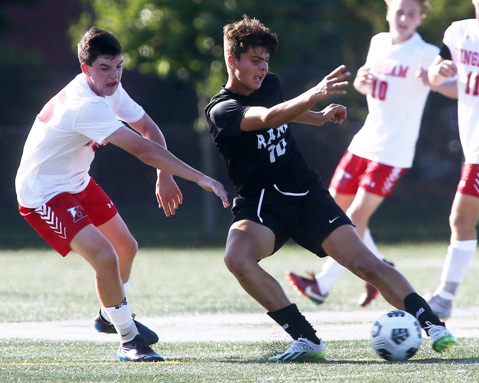 Marshfield’s Kaden Puglia looks to work the ball around Hingham’s Adam Healey during first half action of their game at Marshfield High on Tuesday, Sept. 12, 2023. Hingham would go on to win 5-0.