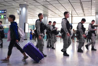 Riot police patrol at airport express central station in downtown Hong Kong, Saturday, Sept. 7, 2019. Hong Kong authorities were limiting airport transport services and controlling access to terminals Saturday as they braced for a second weekend of disruption following overnight demonstrations that turned violent. (AP Photo/Vincent Yu)