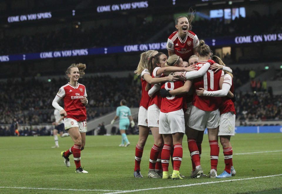 Arsenal celebrate after Vivanne Miedema scores her sides second goal of the match against Tottenham Hotspur during their Women's Super League soccer match at the Tottenham Hotspur Stadium in London, Sunday Nov. 17, 2019. The match drew a record crowd of 38,262 for the competition on Sunday when Arsenal claimed a 2-0 victory at Tottenham. (Zac Goodwin/PA via AP)