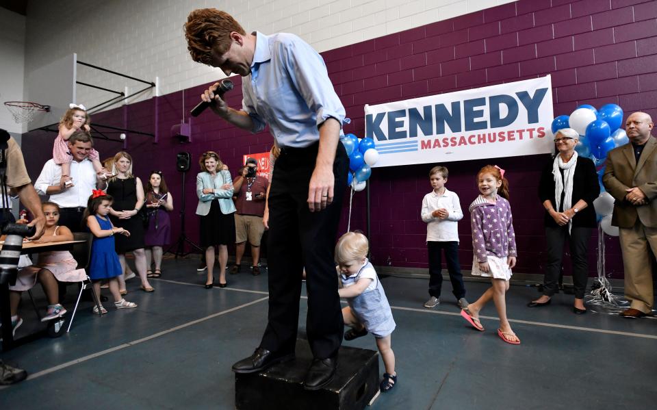 U.S. Rep. Joseph Kennedy III, D-Mass., reacts as his 1-year-old son, James, attempts to climb onto the podium as he announces his candidacy for the Senate on Saturday, Sept. 21, 2019, in Boston.