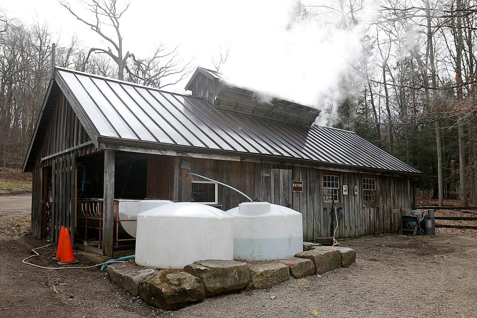 Smoke is seen rising from the Sugar Shack as the sap is boiled to make maple syrup at Malabar Farm Tuesday, Feb. 21, 2023. TOM E. PUSKAR/ASHLAND TIMES-GAZETTE