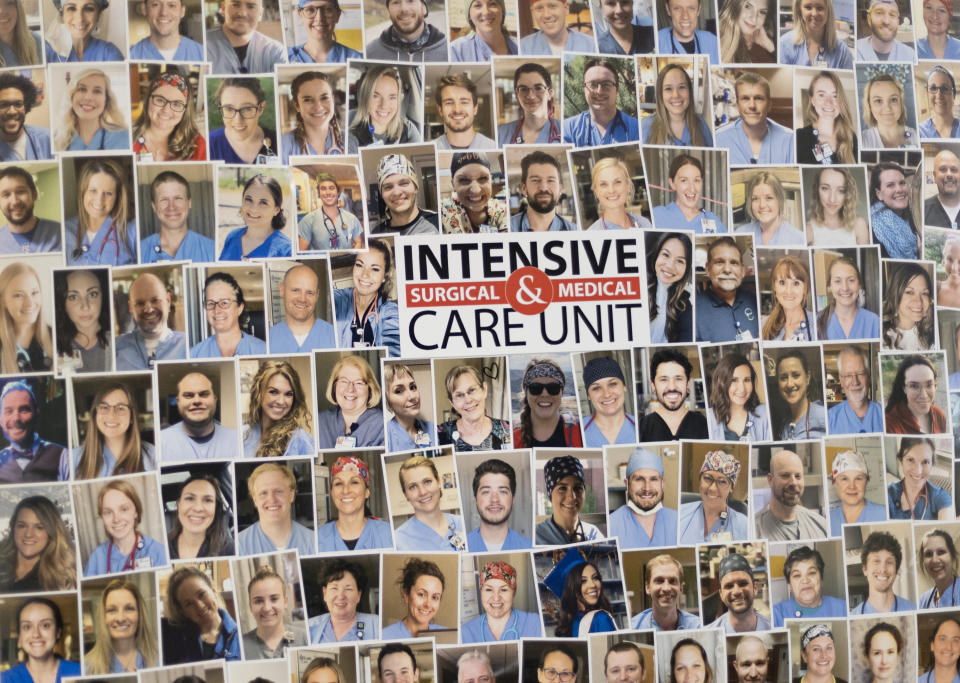 Pictures of health care professionals hang on the wall of the Medical Intensive care unit (MICU) at St. Luke's Boise Medical Center in Boise, Idaho on Tuesday, Aug. 31, 2021. More then half of the patients in the ICU are COVID-19 positive, none of which are vaccinated. (AP Photo/Kyle Green)