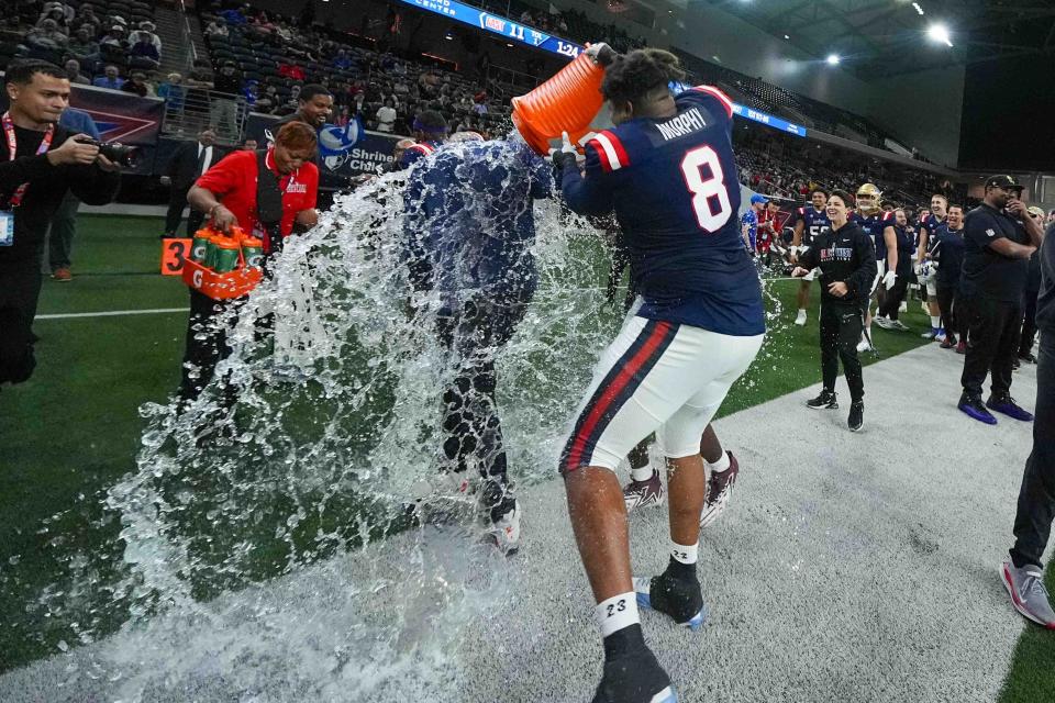 West's Myles Murphy (8), of North Carolina, douses head coach Mike Kafka, of the New York Giants, during the second half of the East West Shrine Bowl NCAA college football game in Frisco, Texas, Thursday, Feb. 1, 2024. (AP Photo/Julio Cortez)