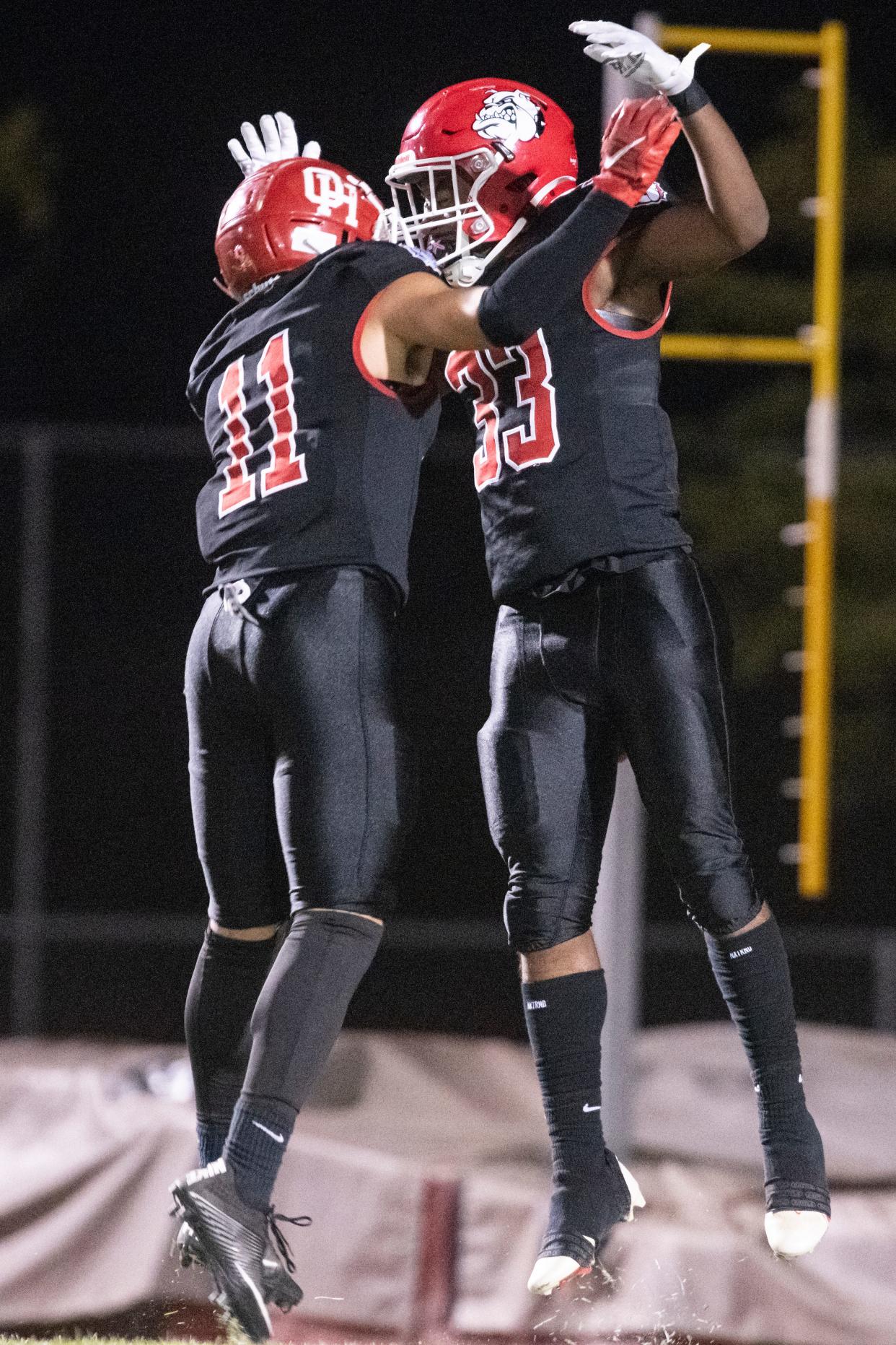 Oak Hills' Karson Cox, right, celebrates with Shea Gabriel after scoring a touchdown against Serrano on Friday, Oct. 14, 2022.