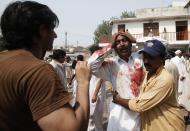 A man cries at the death of his brother at the site of a suicide blast at a church in Peshawar, September 22, 2013. At least 40 people were killed and 70 wounded on Sunday in a suicide bomb attack on a church in the Pakistani city of Peshawar, a local government official said. REUTERS/Fayaz Aziz (PAKISTAN - Tags: RELIGION CIVIL UNREST TPX IMAGES OF THE DAY)