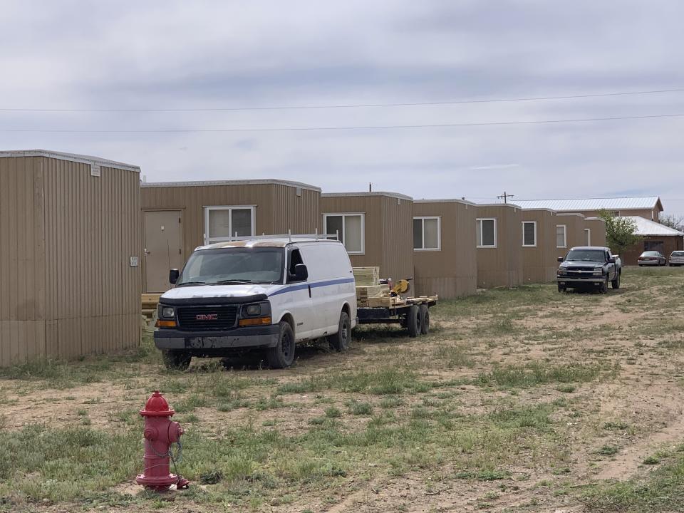 This Monday, April 6, 2020 photo, shows portable housing being erected in Columbus, N.M., for workers who are building a section of the U.S.-Mexico border wall. Immigrant advocates, some village residents and others are raising concerns about the influx of workers from elsewhere given the coronavirus pandemic. (Ray Trejo via AP)