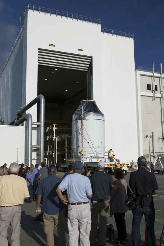 The Orion crew module, on top of a service module, is moved from an operations and checkout building at NASA's Kennedy Space Center on Sept. 11 to a nearby payload hazardous servicing facility. The spacecraft is being readied for a December tes