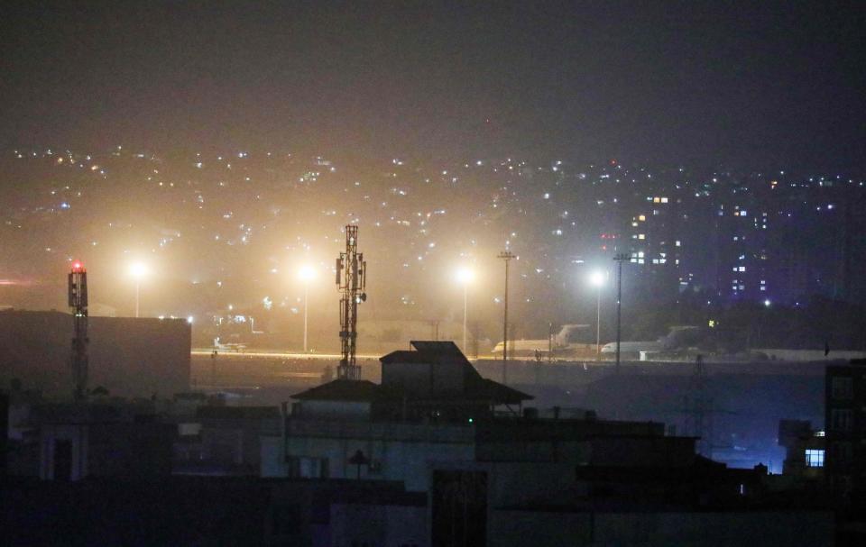 Planes are seen on the tarmac at the airport in Kabul late on August 30, 2021, hours ahead of a U.S. deadline to complete its frenzied withdrawal from Afghanistan.