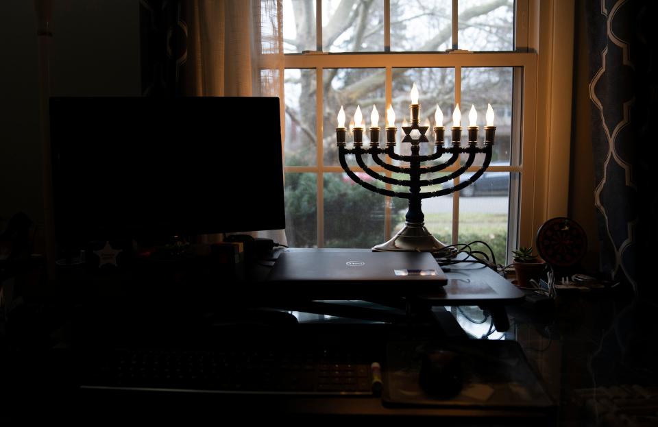 A menorah sits in the window of Andrea and Stephen Britcher in their Worthington home that is decorated for Hanukkah. They will celebrate the beginning of the eight-day holiday on Sunday night.