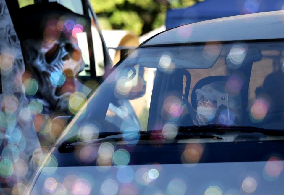 Soap bubbles and Halloween decorations greet visitors at Bruggemeyer Library during the Monterey Park Candy Caravan.