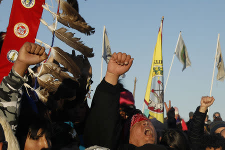 Native American "water protectors" celebrate that the Army Corps of Engineers has denied an easement for the $3.8 billion Dakota Access Pipeline inside of the Oceti Sakowin camp as demonstrations continue against plans to pass the Dakota Access pipeline adjacent to the Standing Rock Indian Reservation, near Cannon Ball, North Dakota, U.S., December 4, 2016. REUTERS/Lucas Jackson