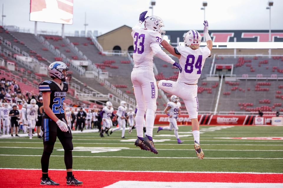 Lehi’s Grayson Brousseau and Jaxon Christensen celebrate after Christensen made a touchdown reception in a 5A football semifinal game against Stansbury at Rice-Eccles Stadium in Salt Lake City on Thursday, Nov. 11, 2021. | Spenser Heaps, Deseret News