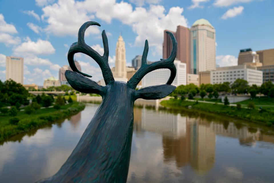 New Mexico artist Terry Allen created three whimsical, humanized bronze deer statues like this one of a buck leaning on the railing of the Rich Street Bridge and overlooking the downtown Columbus skyline and the Scioto River. He did so because the river's name is from the Wyandot word for deer. The Wyandots actually called it "hairy river," according to a 1772 account, because deer were once so plentiful along and around the Scioto that their hair would always be in the waters.