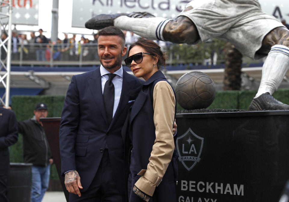 David and Victoria Beckham with a statue of David at Dignity Health Sports Park in Carson, California, in 2019. (Getty Images)