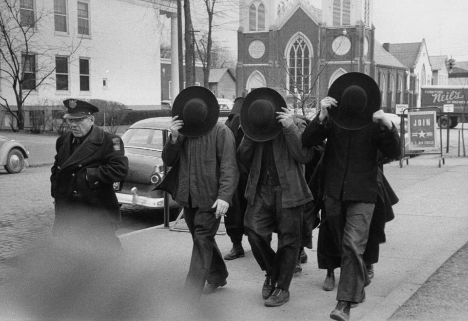 Furtive shot of the Amish, as they go into trial, re truancy of children from public school in 1958.