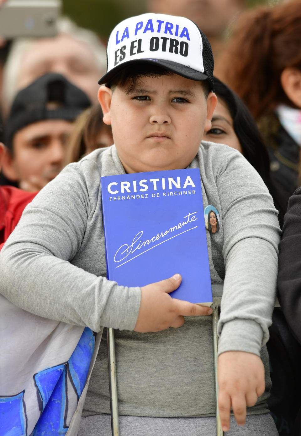 A young supporter of former President Cristina Fernandez, holds a copy of her book, "Sincerely" during a campaign rally at Nestor Kirchner Park in Buenos Aires, Argentina, Saturday, May 25, 2019. After her surprise announcement last week that she will run for vice president in October’s general elections, Cristina Fernandez along with her running mate presidential candidate contender Alberto Fernandez, kicked off their campaign with a political rally on the outskirts of Buenos Aires on Saturday. (AP Photo/Gustavo Garello)