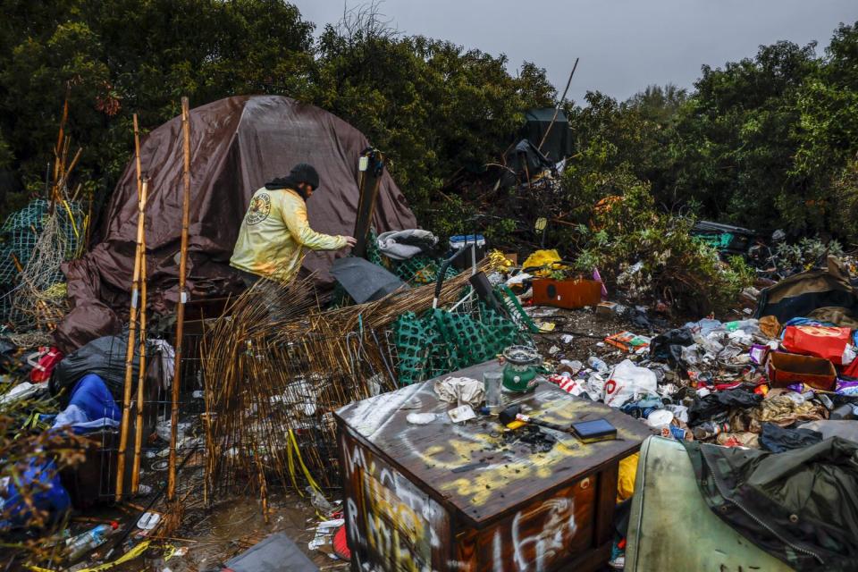 Eddie 'Nugget' Haren walks to his encampment located on the San Gabriel River.