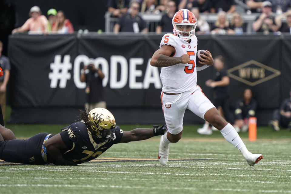 Clemson quarterback DJ Uiagalelei (5) scrambles past Wake Forest defensive lineman Tyler Williams (72) during the second half of an NCAA college football game in Winston-Salem, N.C., Saturday, Sept. 24, 2022. (AP Photo/Chuck Burton)